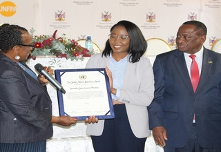 Hon. Theofelus (middle) receives the 2022 United Nations Population Award from Ms. Roseau, UNFPA Namibia Representative.