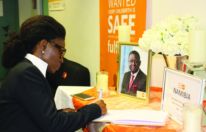 Ms. Kiki Ghebo, UN Namibia Resident Coordinator, signs a book of condolence for Dr. Osotimehin.  (Photo: UNFPA Namibia/Emma Mbekele)