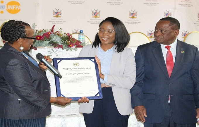 Hon. Theofelus (middle) receives the 2022 United Nations Population Award from Ms. Roseau, UNFPA Namibia Representative.