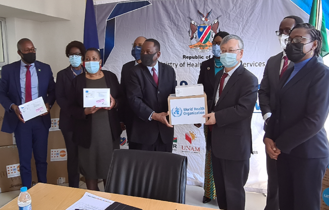 Mr. Sen Pang, UN Resident Coordinator, hands over PPE donation to health minister, Dr. Kalumbi Shangula on behalf of UN Namibia.