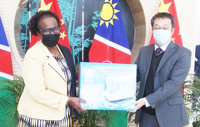 UNFPA Namibia Representative, Sheila Roseau received the sewing machine donation from the Embassy’s Chargé d' Affaires, Mr. Yang