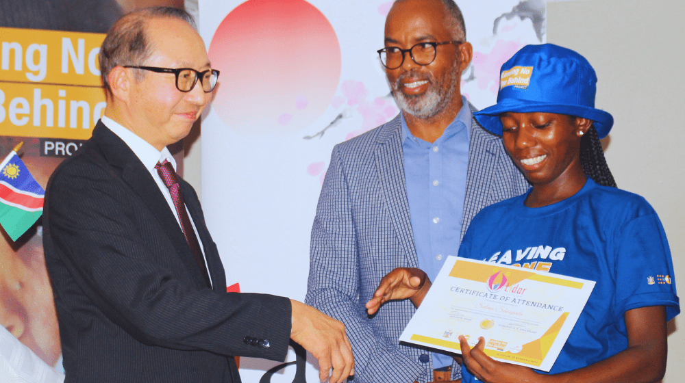 Ambassador H.E. Hisao Nishimaki hands over a certificate to an excited participant alongside Katutura Central Constituency Counc