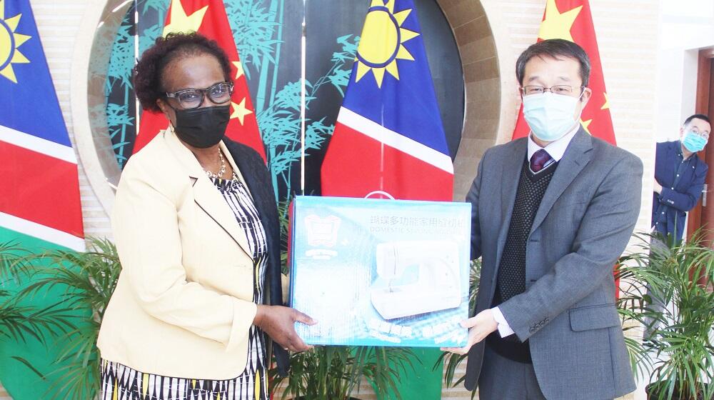 UNFPA Namibia Representative, Sheila Roseau received the sewing machine donation from the Embassy’s Chargé d' Affaires, Mr. Yang